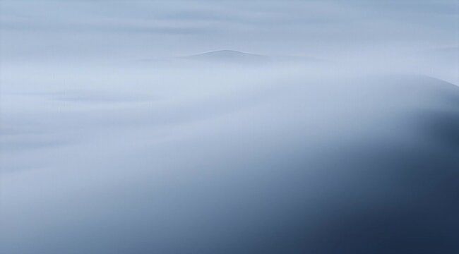 Mystical mountain range shrouded in soft, ethereal, cloudlike fog, peaceful landscape