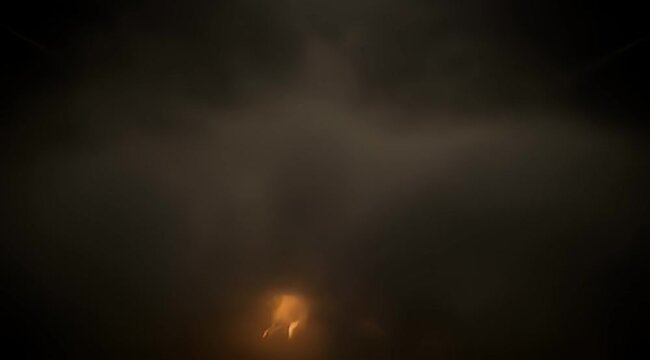 Dark and mysterious background with a faint orange light source at the bottom