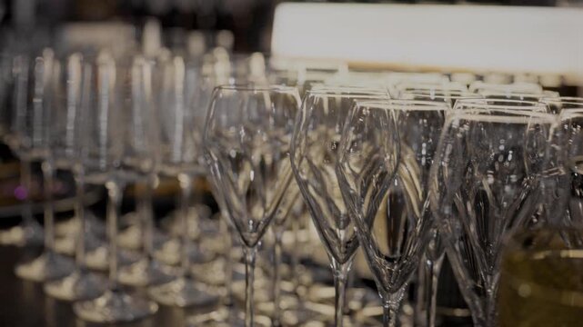 A clean glass goblet. Beautiful clean glasses in a bar and restaurant. Thin glass goblet. Elegant look. Light reflection in a glass goblet.
