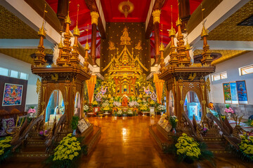 Fototapeta premium Magnificent golden altar with wax statue of Luang Por Uttama revered by Mon community inside Wat Wang Wiwekaram temple in Sangkhlaburi, Kanchanaburi, Thailand