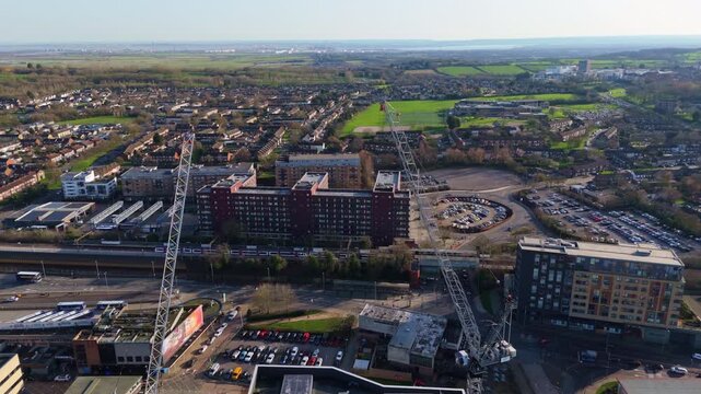 Aerial view of Basildon, UK, featuring cityscape, construction cranes and residential areas