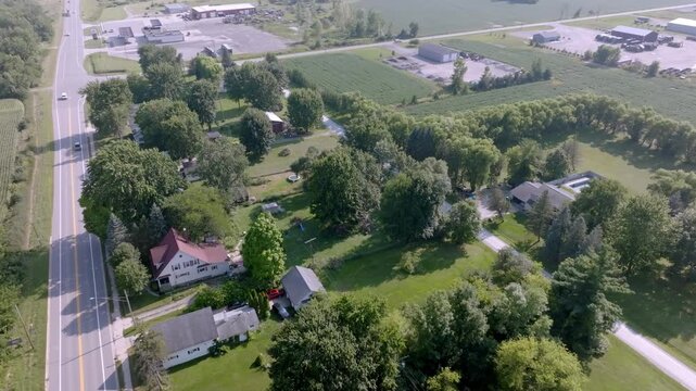 Neighborhood homes in Emmett, Michigan with drone video moving in.