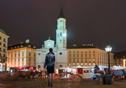 St. Michael's Church with Traditional old-fashioned phaeton at night - Vienna, Austria