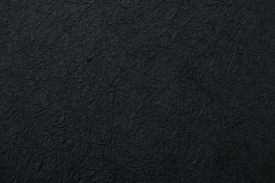 黒い和紙の質感がある和風の背景テクスチャ素材　Black washi paper texture background and Japanese style material
