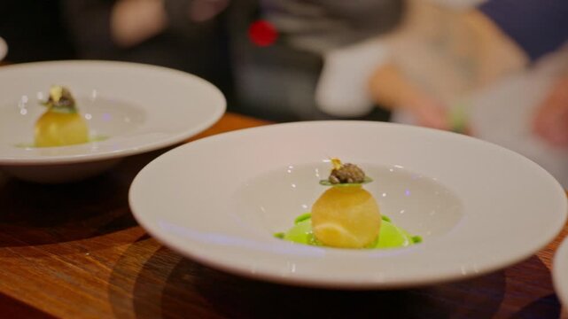 A gourmet dinner at a restaurant. Gastronomic food and dishes. Decorations and sophistication of signature dishes from the chef. Food as art. Bright colors of the dishes.