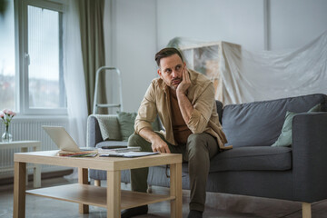 Man feeling overwhelmed with home renovation project