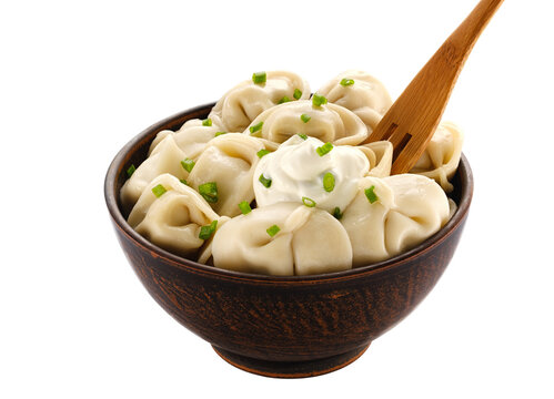 Homemade meat dumplings - russian pelmeni. Dumplings, filled with meat on white background. Isolated on white