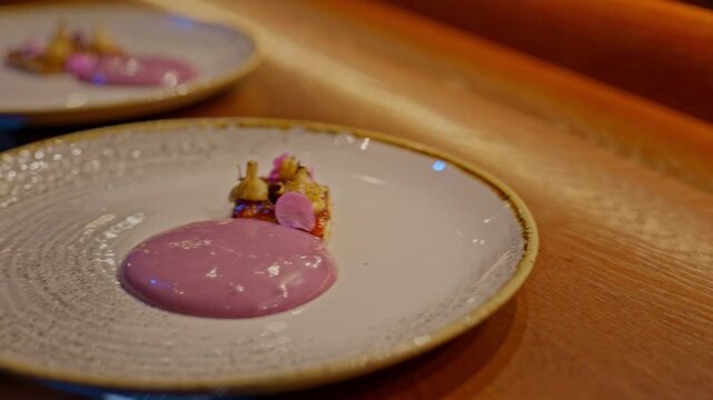 A gourmet dinner at a restaurant. Gastronomic food and dishes. Decorations and sophistication of signature dishes from the chef. Food as art. Bright colors of the dishes.