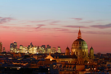 The Saint Augustin church and parisian houses with modern skyscrapers of business La Defense district in the background, Paris . France