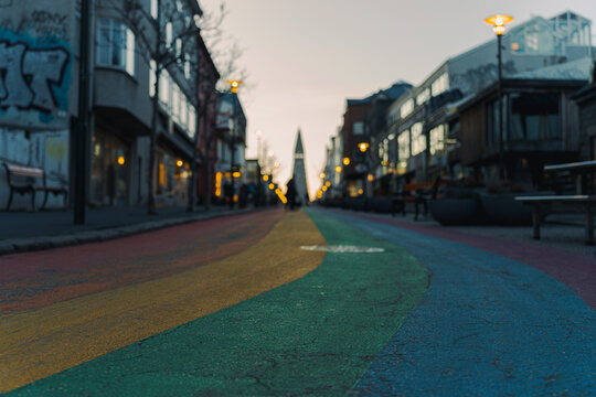 Wide horizontal view of the curved rainbow street art in Reykjavik at sunrise.