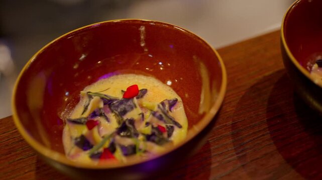 A gourmet dinner at a restaurant. Gastronomic food and dishes. Decorations and sophistication of signature dishes from the chef. Food as art. Bright colors of the dishes.