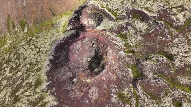 A drone glides above Eldborg crater, revealing a circular volcanic cone, dark red lava terrain, and striking geological patterns formed by ancient eruptions in Iceland&rsquo;s Reykjanes region