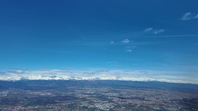 An immersive pilot&rsquo;s view in the final approach to Turin (TRN) airport in a winter day with the snow-capped Alps mountains in the background.