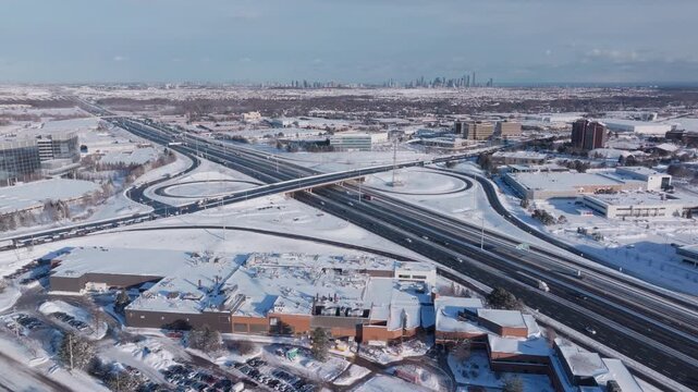 Aerial view of snowy HWY 401 with Mississauga skyline in background