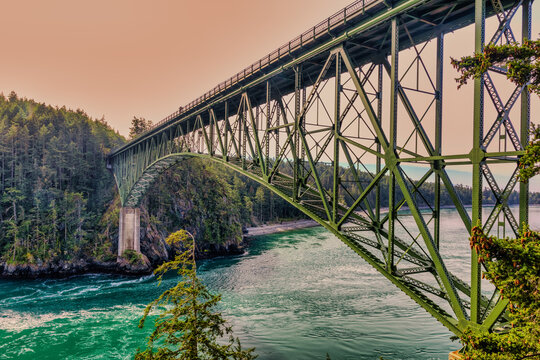 Iconic Deception Pass Bridge over turbulent turquoise waters.