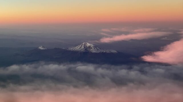 Aerial view of Mt. Ararat and Little Mount Ararat at sunset with colorful clouds and snowy peaks. Turkish name Ağrı Dağı