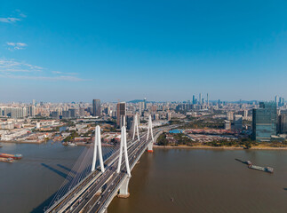 Obraz premium Aerial view Panoramic view of Guangzhou, China. Bridge and skyline against clear blue sky landscape