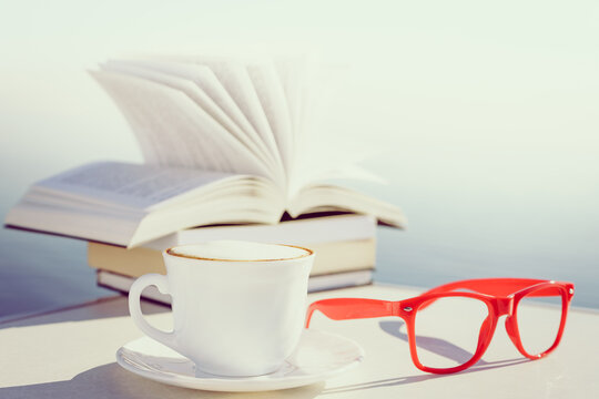 Coffee cup and books outdoors
