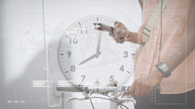 Animation of data processing and ticking clock over mid section of man with bicycle using smartphone