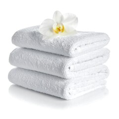 Stacked white towels with a white orchid flower on top, against a clean white backdrop