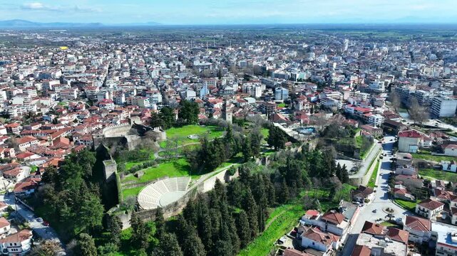 Aerial drone cinematic rotational video of iconic Byzantine castle of Trikala ancient citadel built northeastern side of the city in a small hill featuring clock tower with great views in old city of 