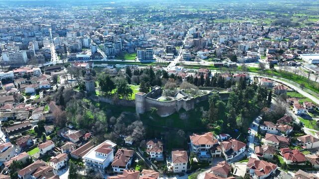 Aerial drone cinematic rotational video of iconic Byzantine castle of Trikala ancient citadel built northeastern side of the city in a small hill featuring clock tower with great views in old city of 