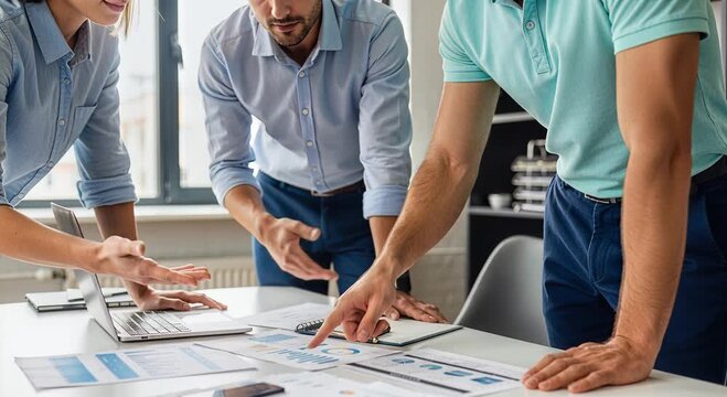 Group of professionals reviewing charts and data documents