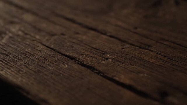 Close-up of aged wooden surface, showcasing grain and cracks in various shades of brown