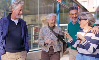 Happy senior friends laughing together outdoors