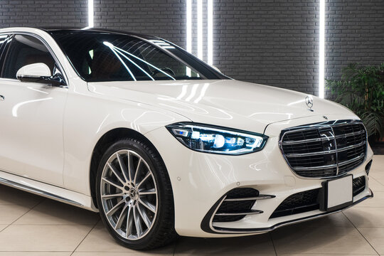 White Mercedes-Benz S-Class 580 L VII W223 sedan in the showroom after detailing. Exterior of a white Mercedes-Benz S-Class 580 L VII W223. Germany premium car. Wrapping car.