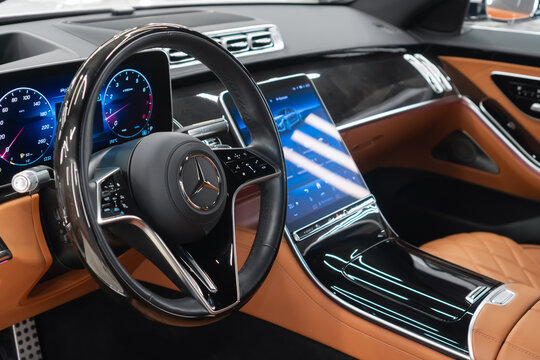 Mercedes-Benz S-Class 580 4MATIC VII W223, limousine, luxury car interior, steering wheel, seats, armrest, shift knob, dashboard, ambient light. Beige leather car interior. German premium sedan.