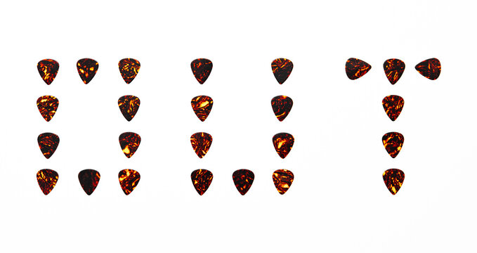 Out word sign made of guitar plectrums. These are classic brown celluloid tortoise shell picks. Concept for rock album or EP release. Isolated on white background.