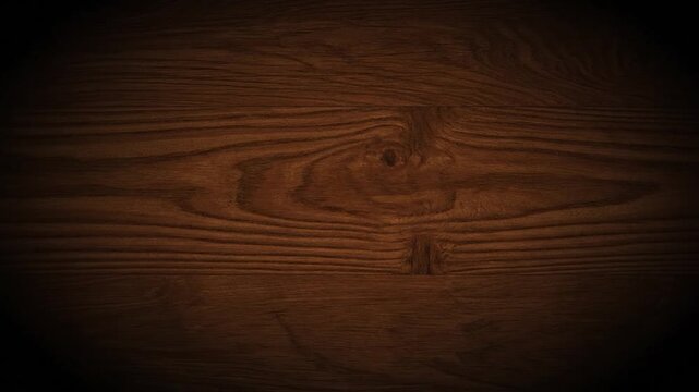 Close-up of richly-grained, dark brown wood paneling, featuring knots and textures