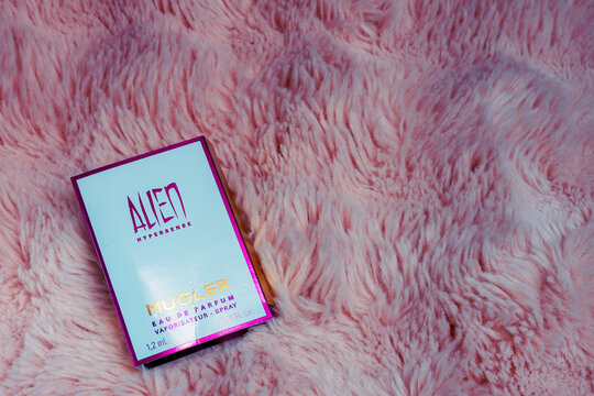 Sollentuna, Sweden, February 8, 2026:A close-up photo of a sample of Mugler's Alien Hypersense perfume against a soft pink faux fur background, highlighting the symbolism of the luxurious scent