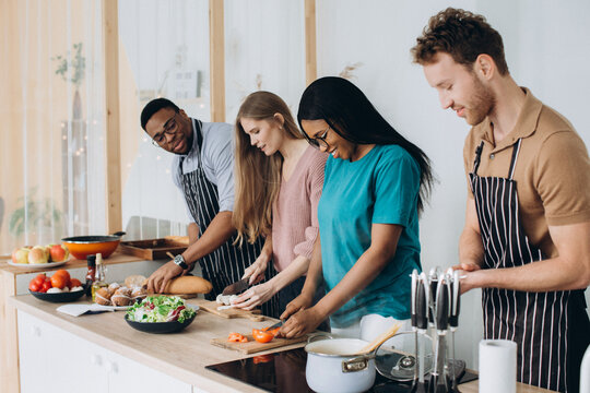 Diverse friends cooking dinner preparing healthy meal