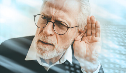 Senior man with hearing problems; light effect