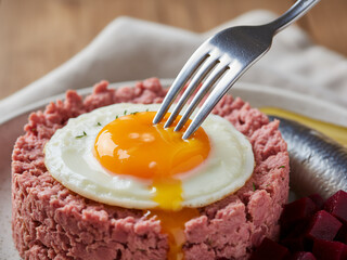 Fork Cutting into Traditional German Labskaus Close-Up