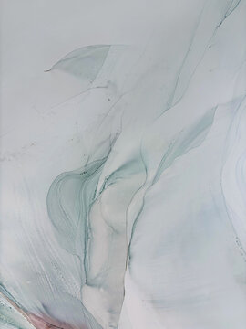 Abstract pale green hand made aquarelle background with beige. Beautiful watercolor artwork made with alcohol ink. Light green smoky fluid art texture resembles green mist, marble, water, ocean, flow.