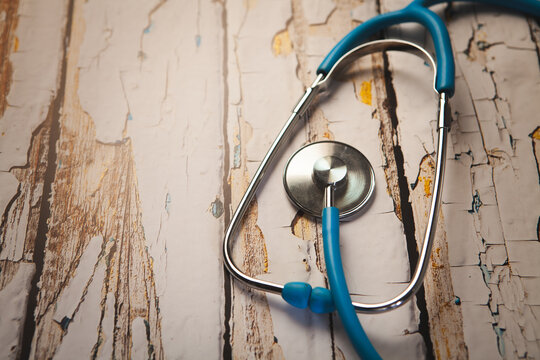 medical stethoscope on wooden background. health insurance concept