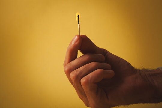 man hand with yellow nail on yellow background.