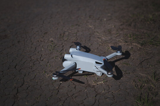 drone with white camera on the asphalt road in the evening, the sunset