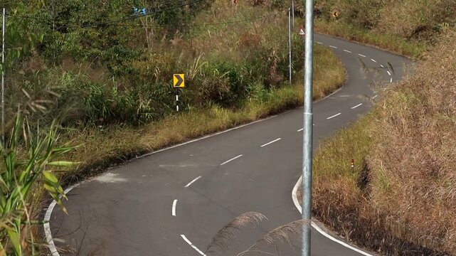 Winding Mountain Road Through Grassy Hillside