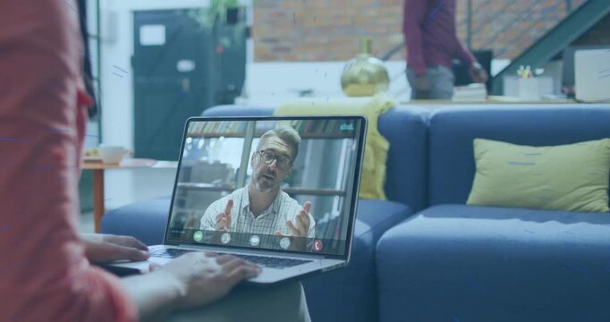 Seated woman typing while business call starting, remote speaker gesturing, laptop icons appearing
