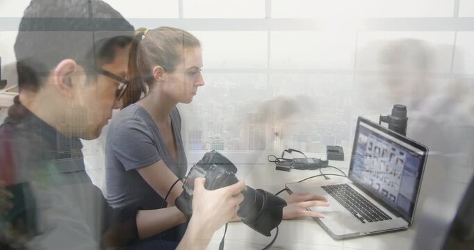 Camera op adjusting DSLR editor scrolling laptop thumbnails selecting shots for edit ghosted people