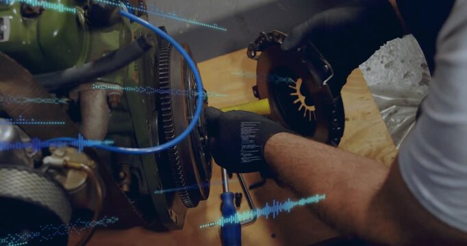 Tech checking bolts, removing clutch plate from flywheel for auto while waveform overlay tracking