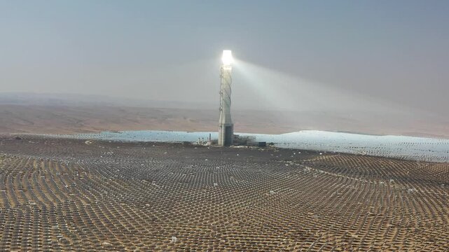 Aerial view of Ashalim solar power station tower and heliostats in the Negev desert wilderness Israel
