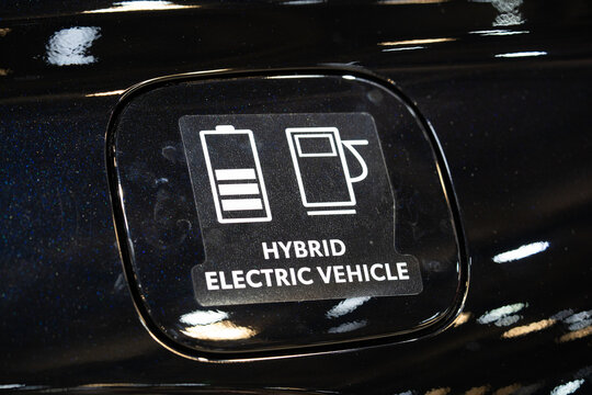 Close up of hybrid electric vehicle badge on car body