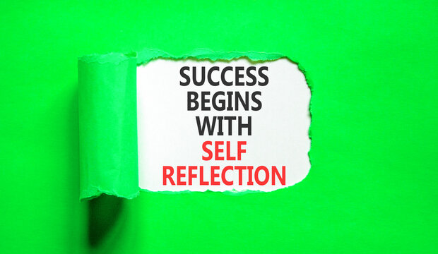 Self reflection symbol. Concept words Success begins with self reflection on beautiful white paper. Beautiful green paper background. Business success begins with self reflection concept. Copy space.