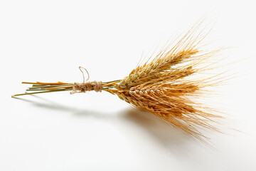 Naklejka premium Wheat bundle placed on a plain background during daytime