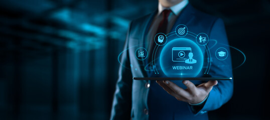 Businessman Holding tablet with Webinar Icons on Screen. E-learning and Education Concept